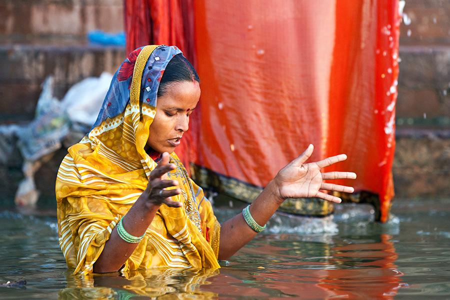 A woman in the Ganges River, Varanasi, india