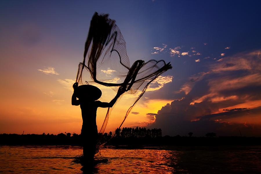 A fisherman in the Mekong River, Vietnam 