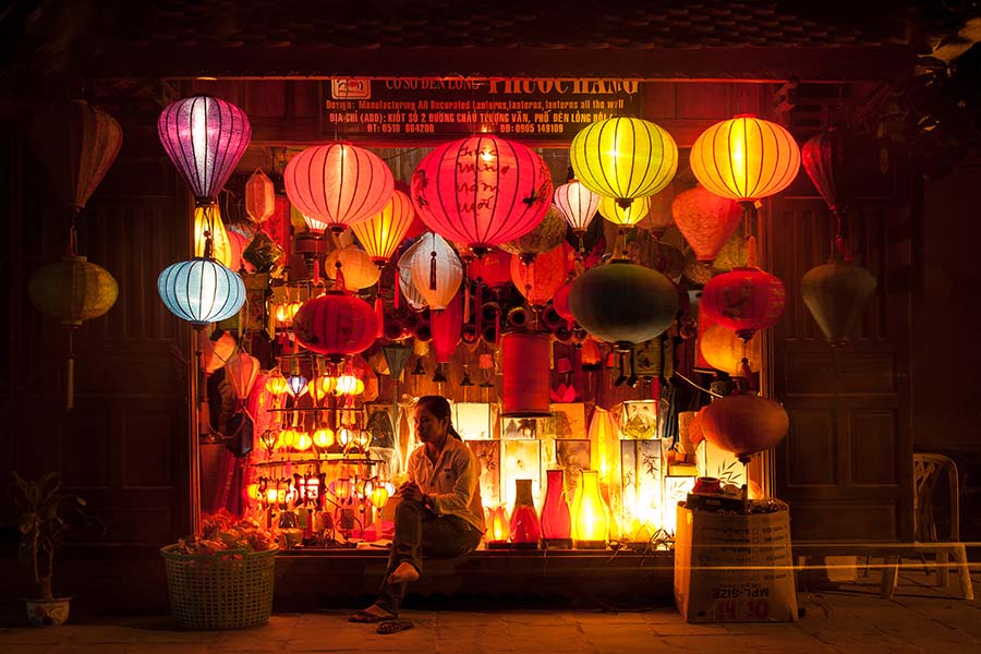 A woman sat outside a lantern shop in Vietnam